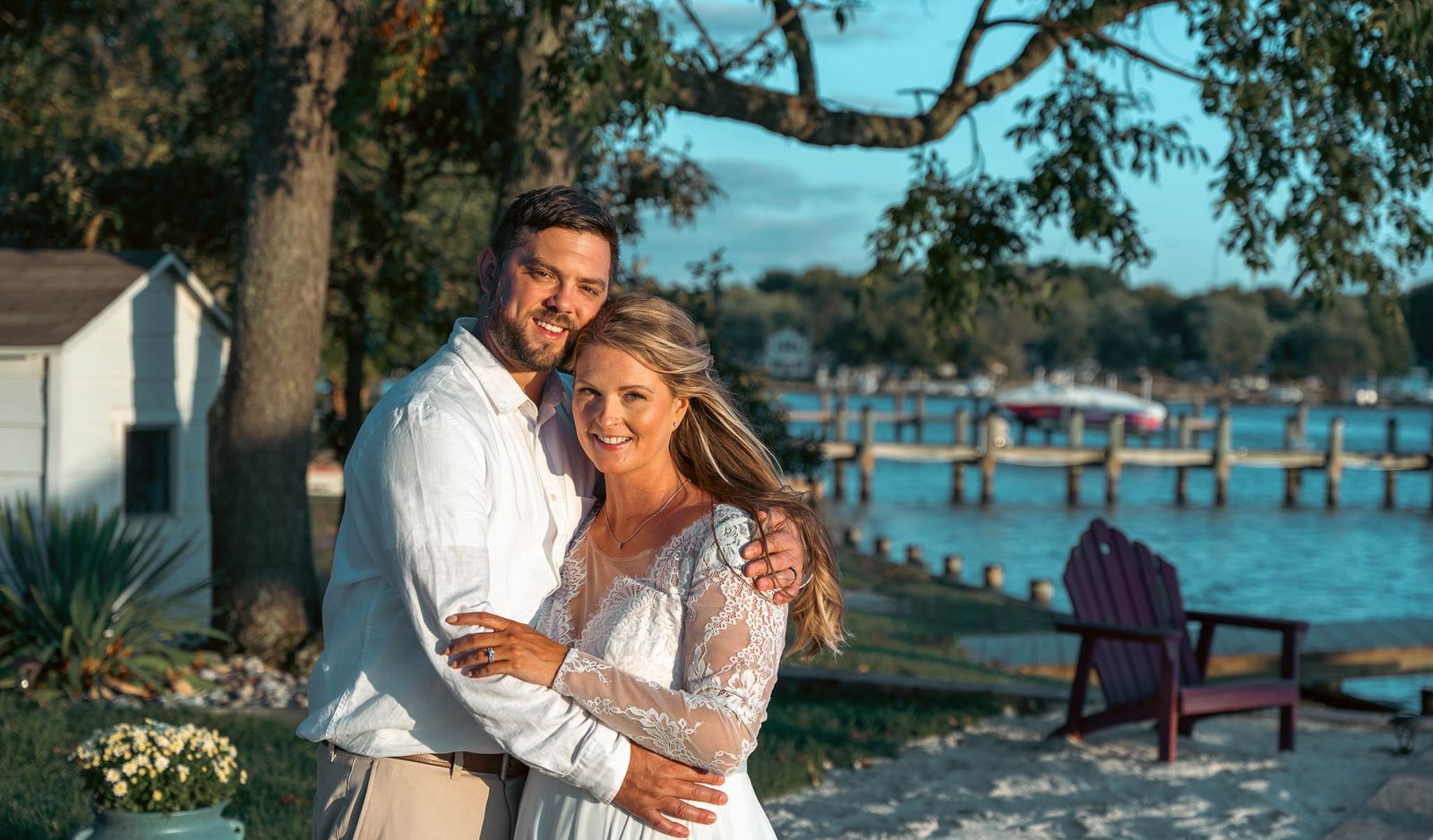 Bride and groom at golden hour with the creek and dock behind them — backyard wedding in Annapolis, Maryland